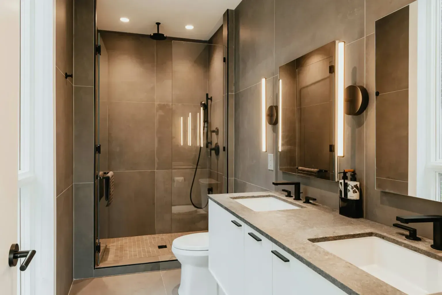 Bathroom remodel in Converse Tx — a tradesperson making a careful final pass over the finished work