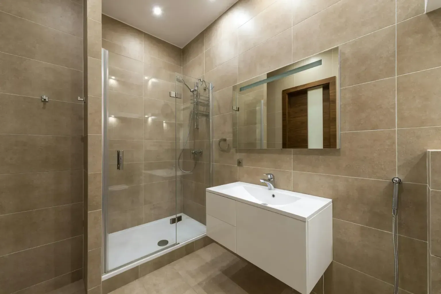Bathroom remodel in Universal City Tx — clean unbroken lines of completed work running toward a commercial suite window